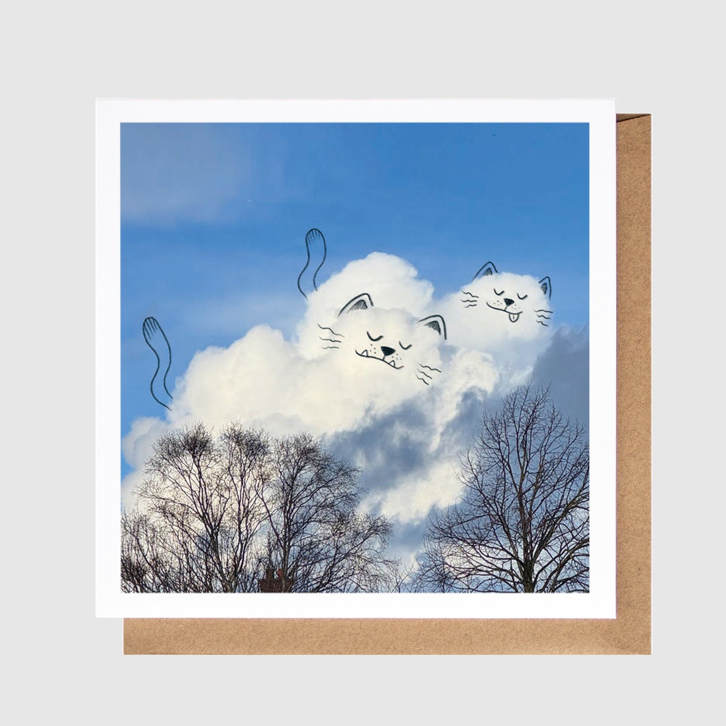 Card with a design of cats in clouds against a blue sky, with a brown border.
