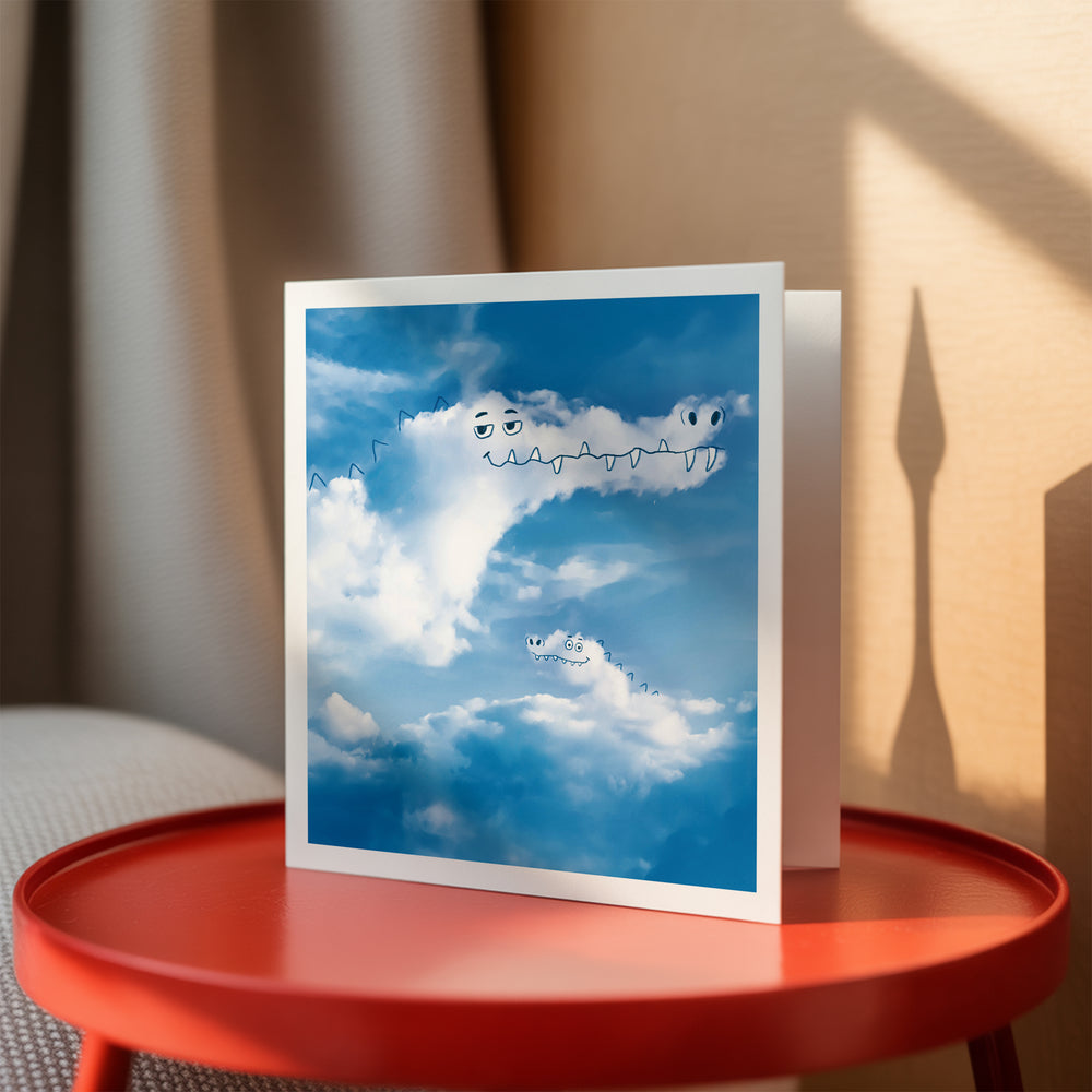Card with cloud crocodile designs on a red table