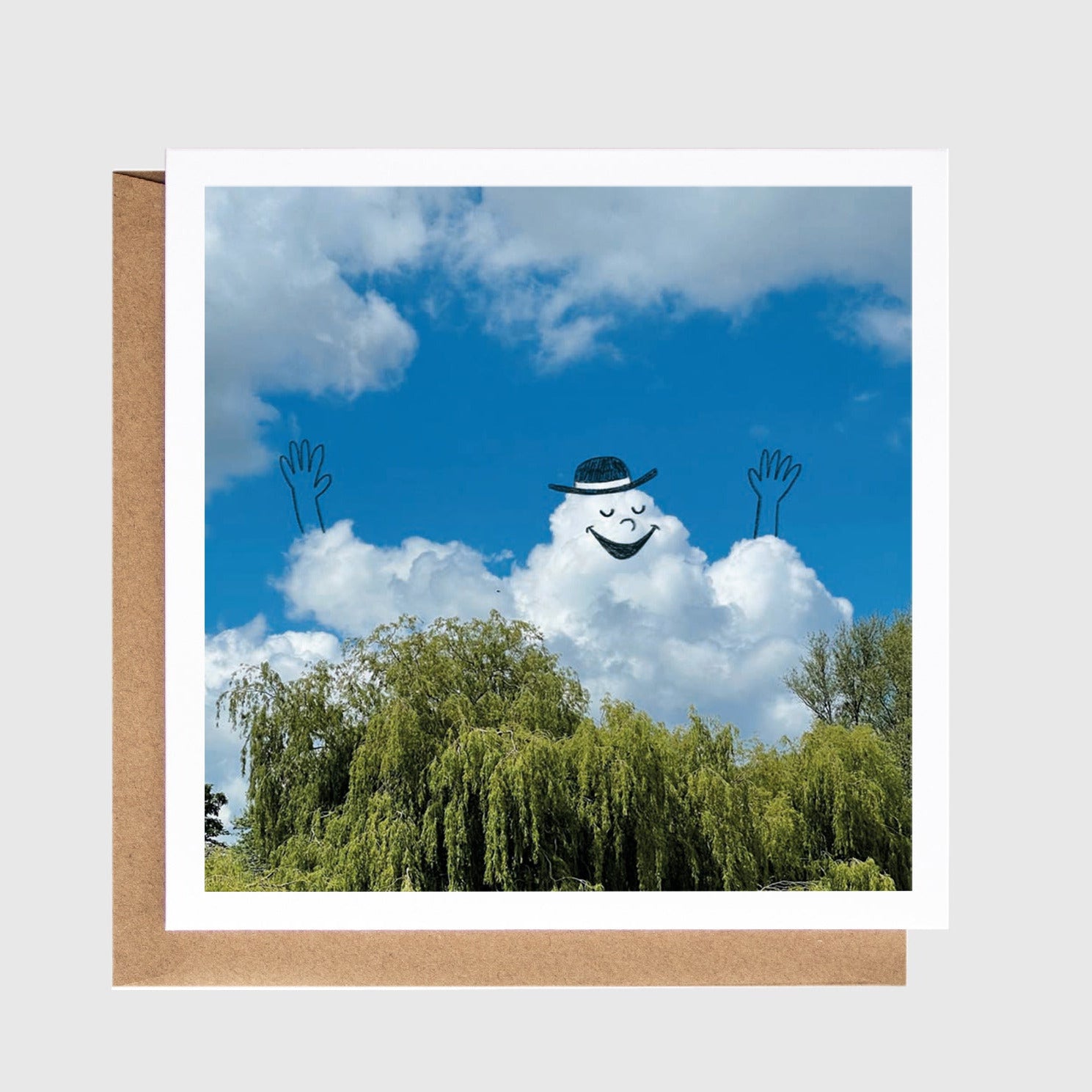 Cloud with a face and arms in the sky above trees