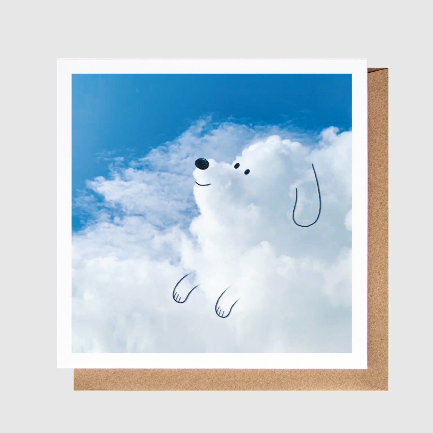 Card with a cartoon dog in the clouds against a blue sky