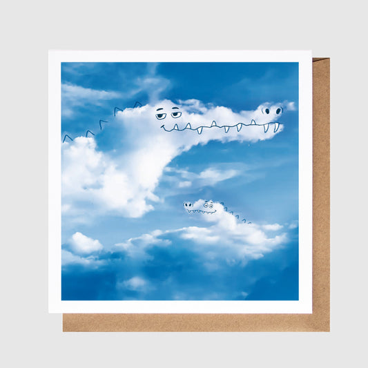Card with a cloud design and crocodiles on a blue sky background