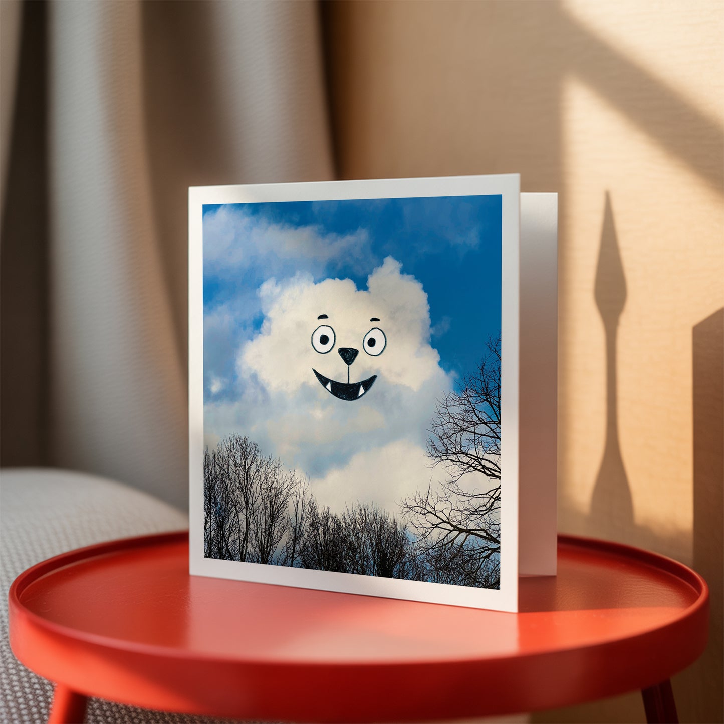 Greeting card with cloud design on a red table