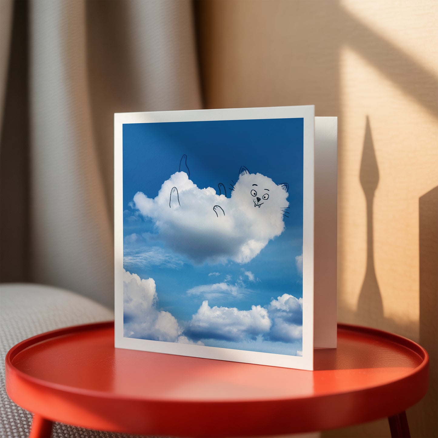 Greeting card with cloud design on a red table