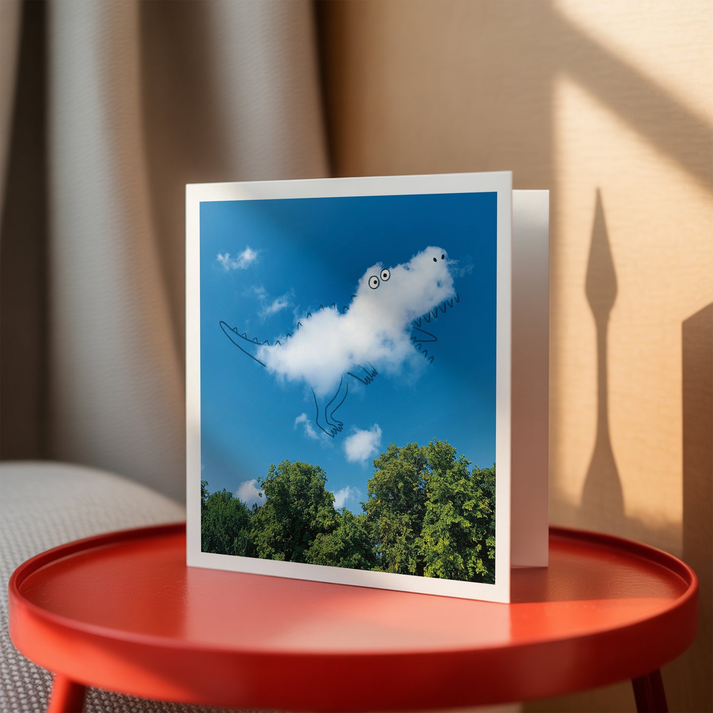 Greeting card with cloud design on a red table