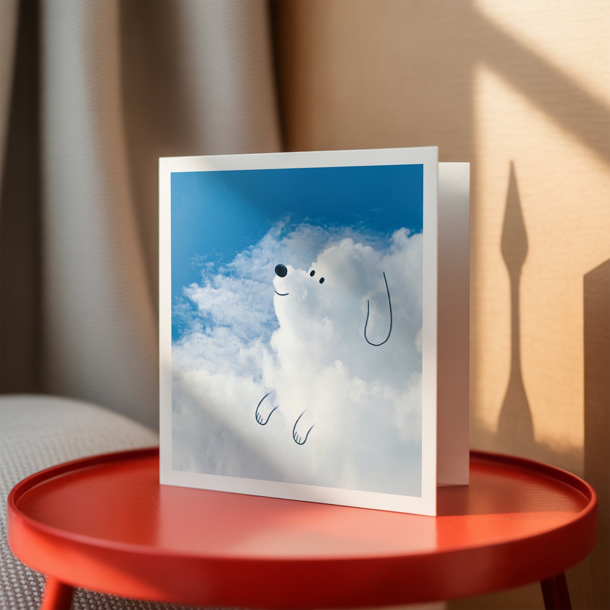 Card with a cloud design on a red table