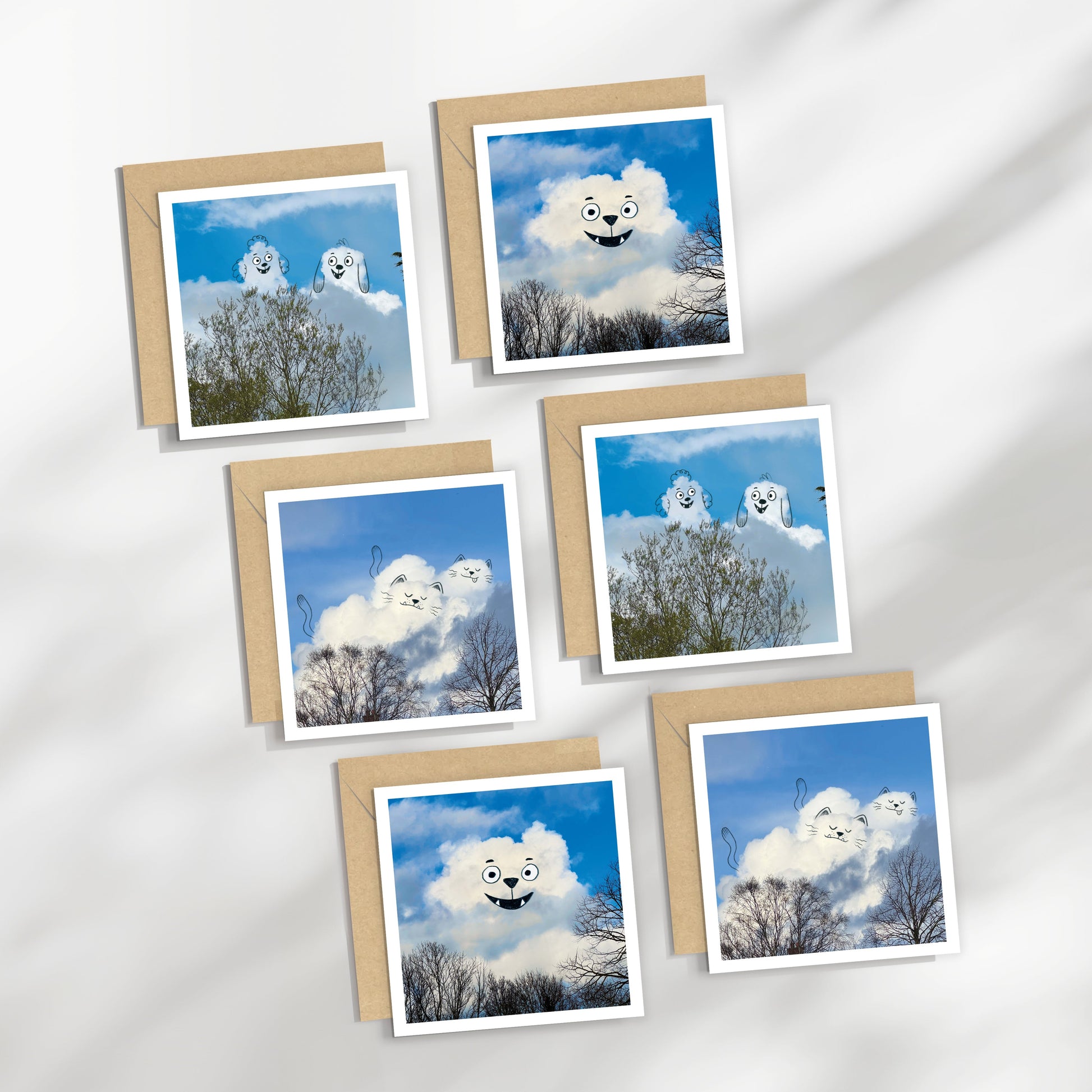Set of greeting cards with cloud-themed designs on a white background, cats, dogs and bears.