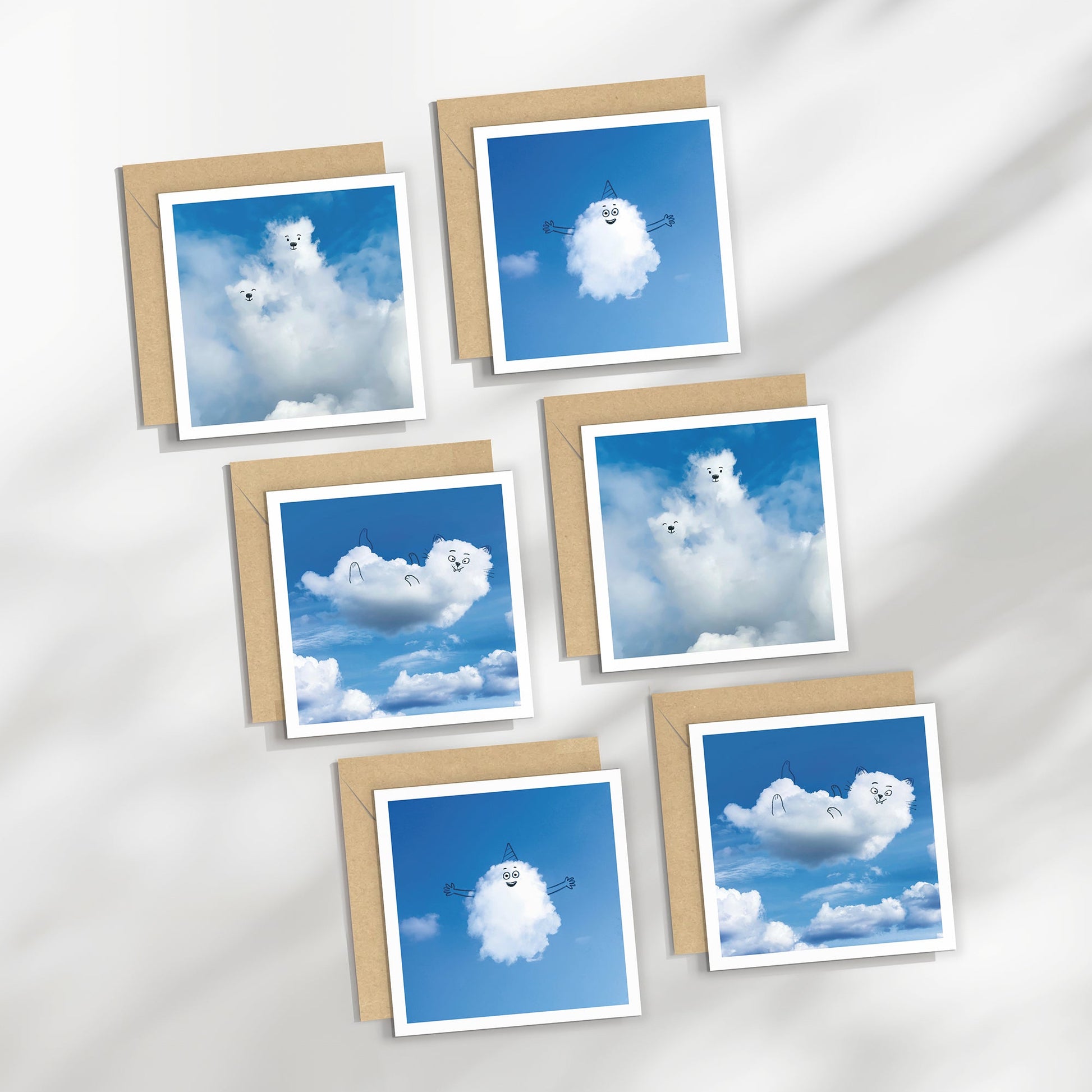 Set of six greeting cards with cloud designs on a white background
