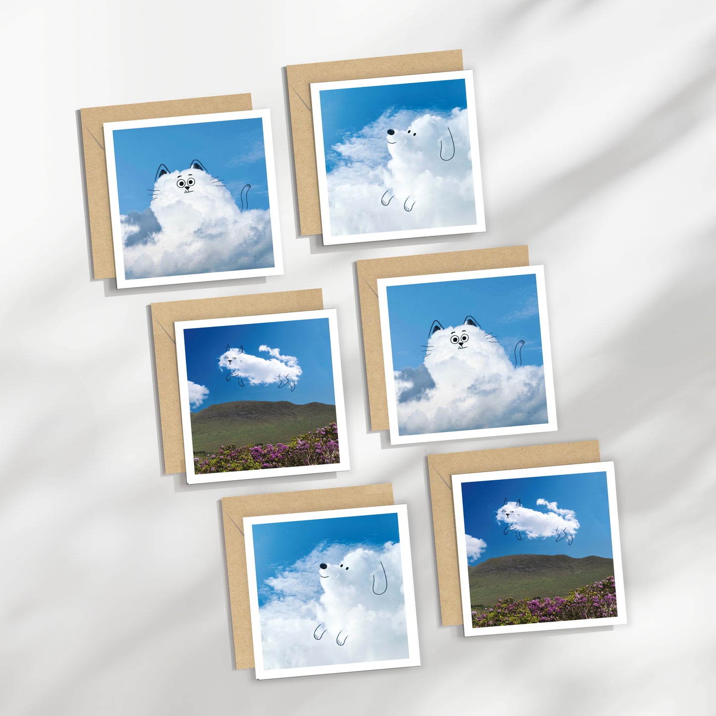 Set of six greeting cards with cloud-themed designs on a white background