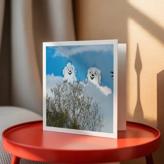 Card with cloud-themed design on a red table
